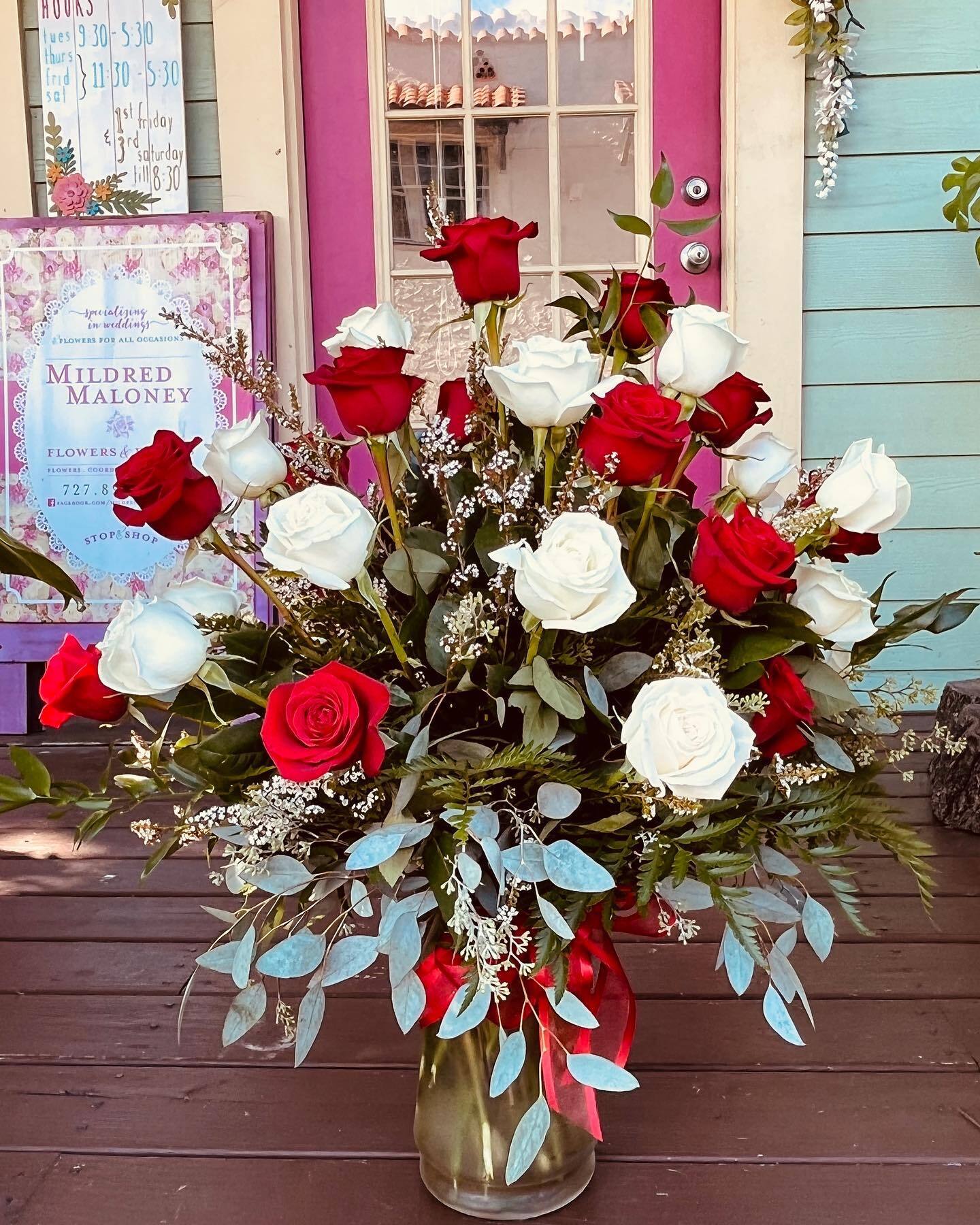 Red and white roses arrangement outside Mildred Maloney Flowers